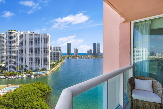 View of high-rise buildings and waterway from a balcony.