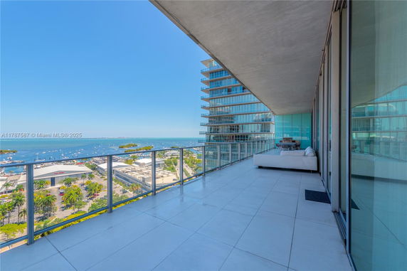 High-rise building balcony with ocean view.