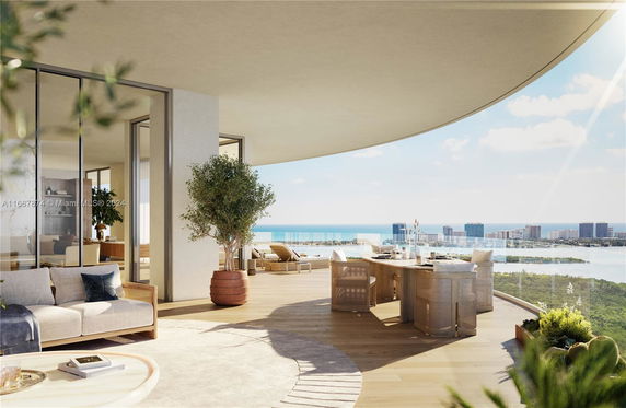Panoramic view of a balcony overlooking the ocean and cityscape.