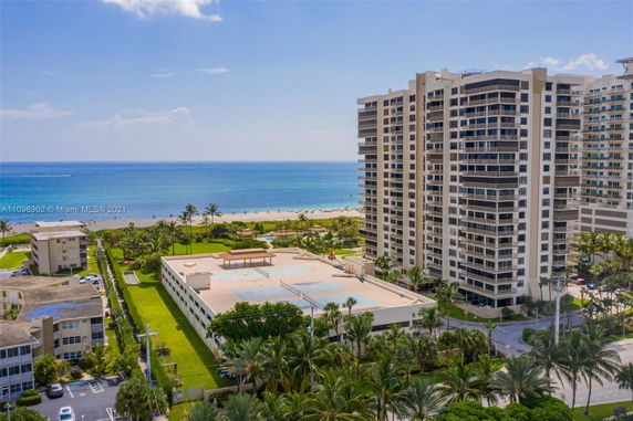 View of a beachfront high-rise building next to the ocean.