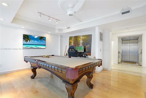 Room with a pool table and modern decor.