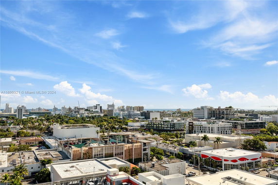 Panoramic view of a cityscape with multiple buildings and a clear sky.