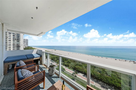 Panoramic view from a balcony overlooking the beach and ocean.