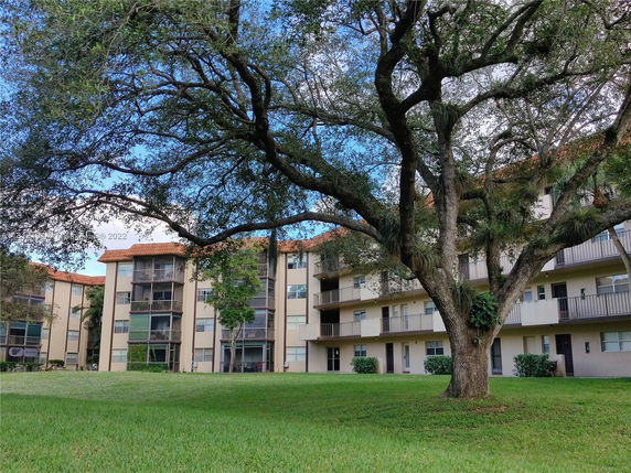 Front view of a multi-story residential building with balconies.