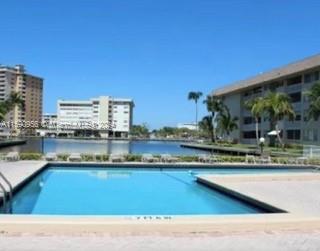 Outdoor swimming pool with buildings in the background.