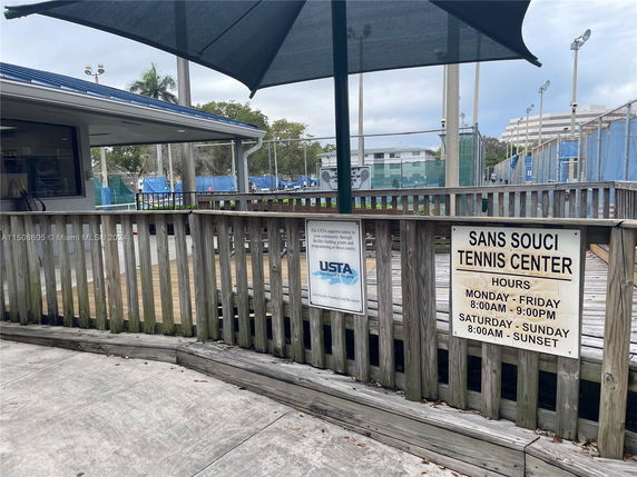 Tennis center area with outdoor courts and surrounding facilities.