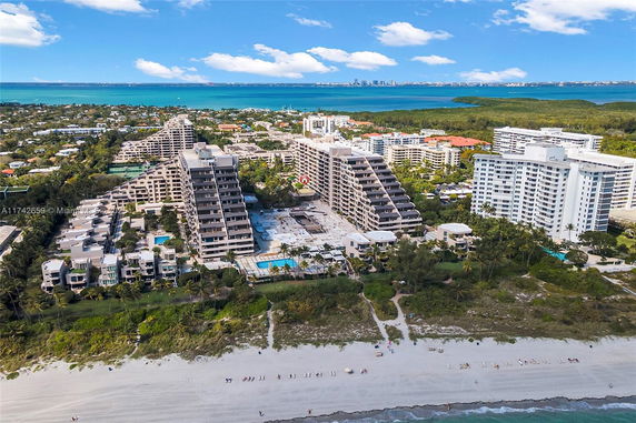 Aerial view of beachfront condominium buildings near the ocean.