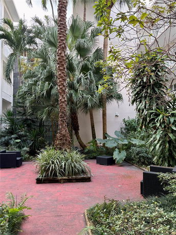 Outdoor area with lush vegetation and seating.