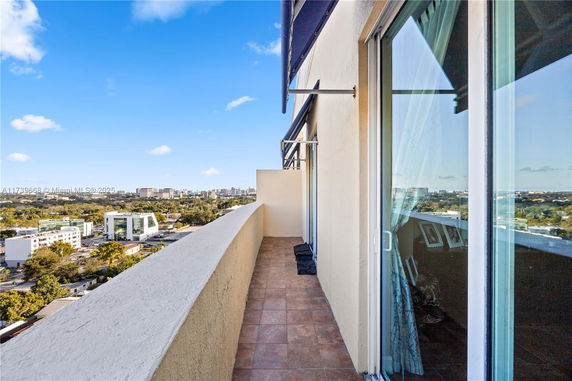 Elevated view overlooking cityscape from a building balcony.