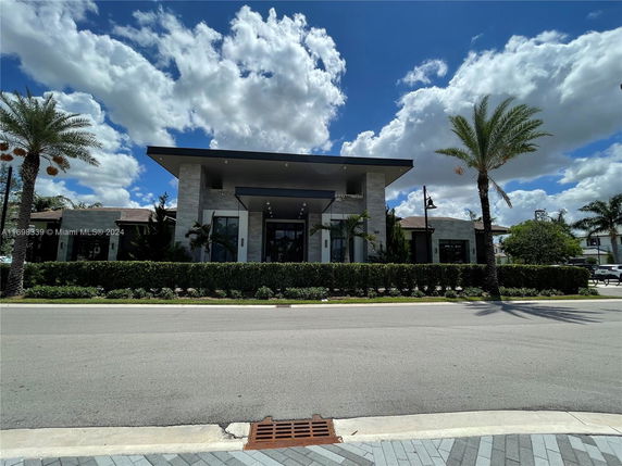 Front view of a modern, single-story building with large windows and a flat roof.