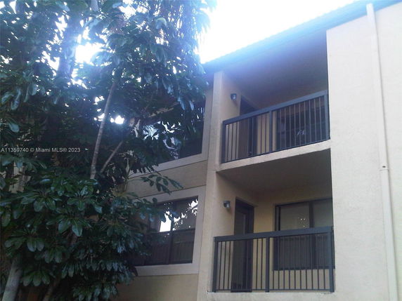 Corner view of a multi-story building with balconies.