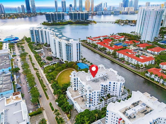 Wide angle view of a cityscape with high-rise buildings and a body of water.
