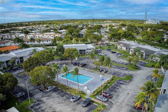 Aerial view of a residential area with swimming pool and parking spaces.