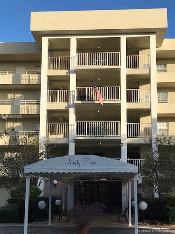 Front view of a multi-story residential building with balconies.