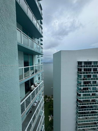 View from a high-rise building overlooking a body of water with another building visible.