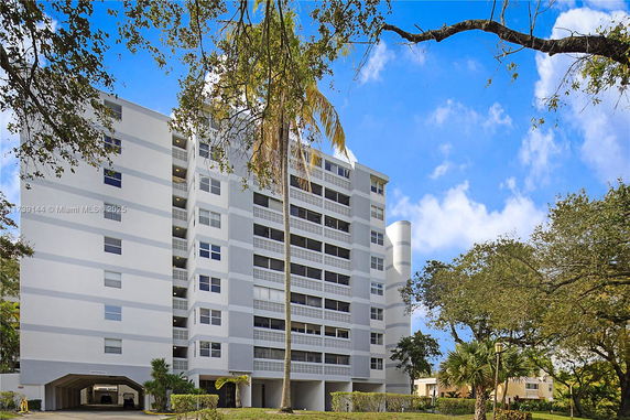 Front view of a multi-story residential building with balconies.