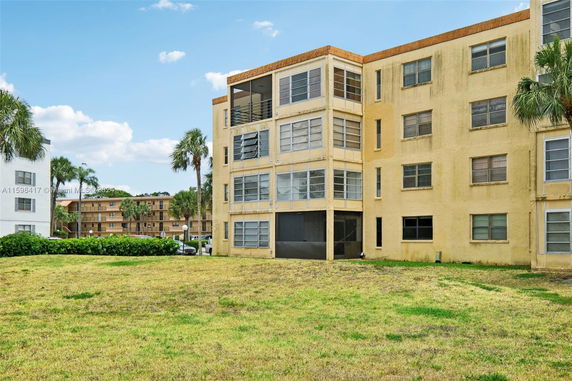 Front view of a multi-story residential building with balconies.