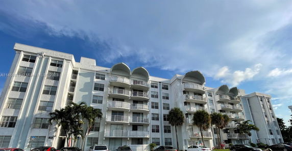 Front view of a multi-story residential building with balconies.