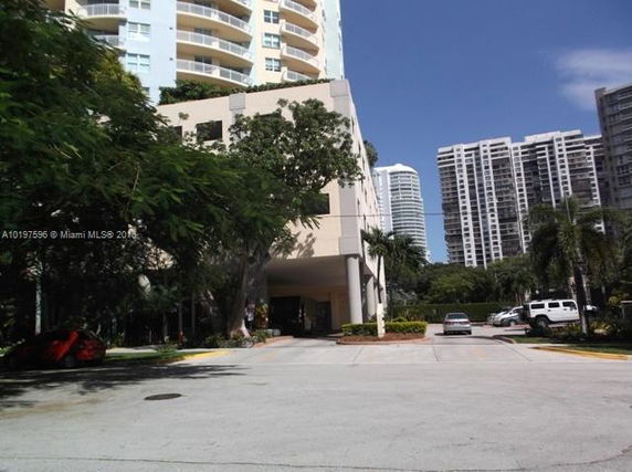 Front view of a modern multi-story residential building with balconies.