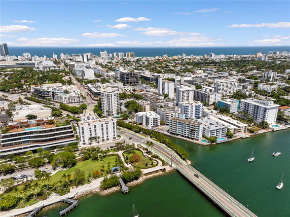 Wide angle view of a cityscape with buildings and a waterfront.