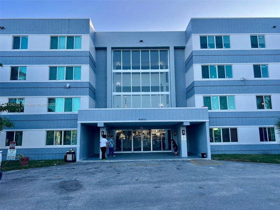 Front view of a multi-story building with large windows and entrance.