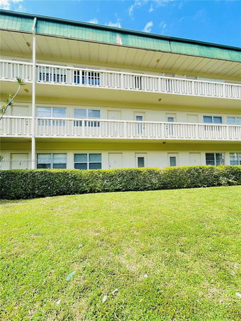 Front view of a multi-story building with balconies.
