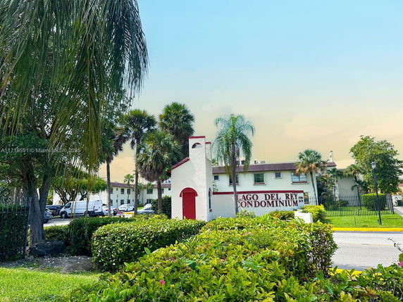 Front view of a condominium building with a sign reading 'Lago Del Rey'.