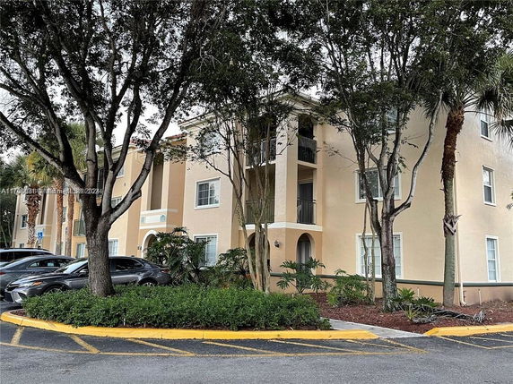 Front view of a multi-story residential building with multiple balconies.