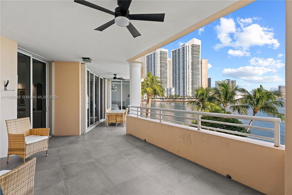 Balcony view with high-rise buildings and water view.