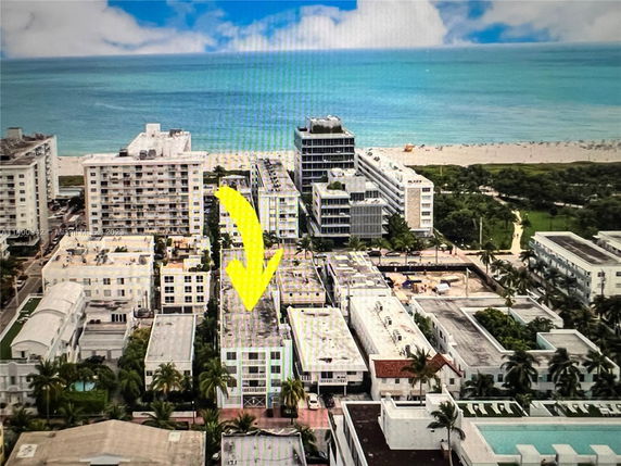 Aerial view of a coastal area with multiple buildings near the ocean.