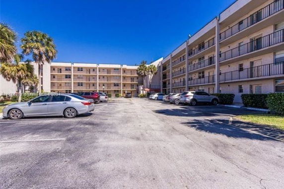 Outdoor parking area in front of a multi-story building.