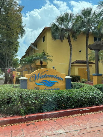 Front view of a building with 'Waterview' sign and palm trees.