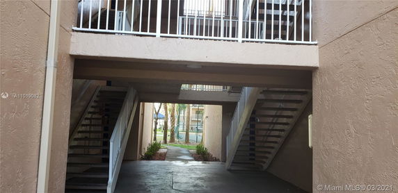 Exterior view of a building with staircases and railings.