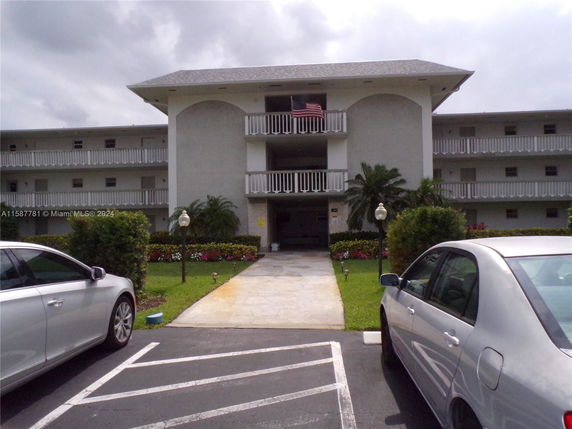 Front view of a multi-story residential building with balconies.
