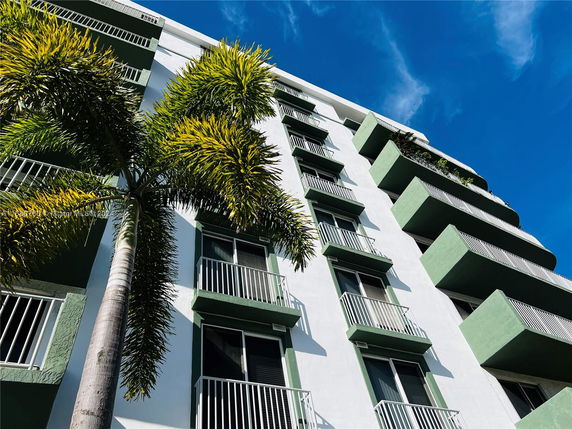 Front view of a multi-story residential building with balconies.