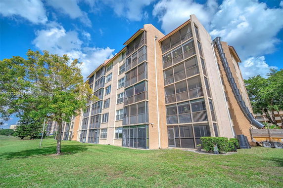Front view of a multi-story apartment building with balconies.