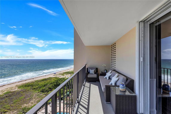 Balcony view overlooking a beach and ocean.