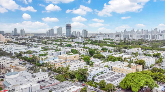 Panoramic view of a cityscape with buildings and greenery.