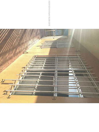 Side view of a building with barred windows.
