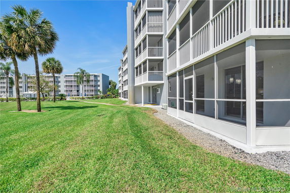 Front view of a multi-story apartment building with balconies.