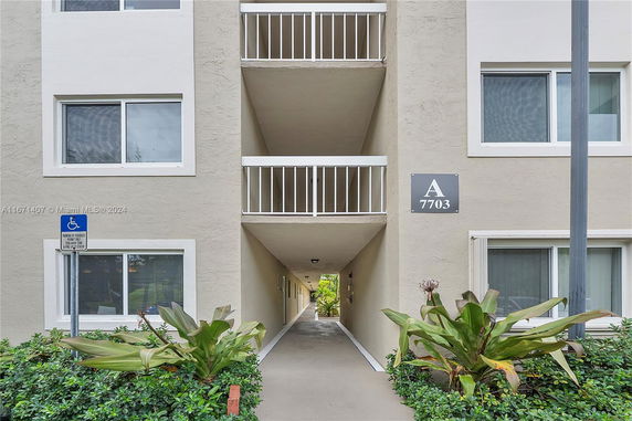 Front view of a multi-story building with hallway entrance.