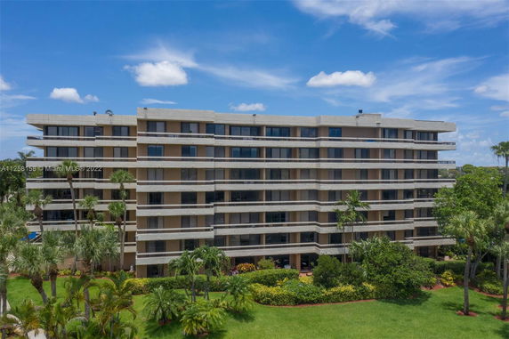 Front view of a multi-story residential building with large balconies.