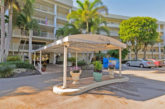 Front view of a multi-story building with a covered entrance.