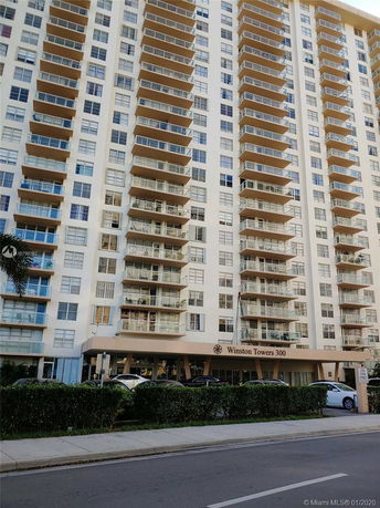Front view of a multi-story residential building with balconies.