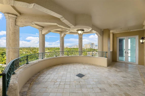 Panoramic view from a building terrace with columns and railing.
