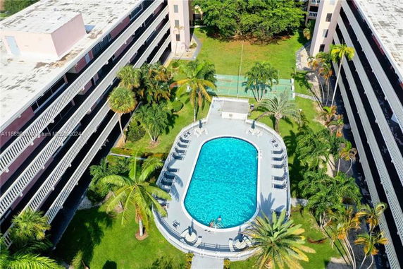 Aerial view of a swimming pool surrounded by buildings.