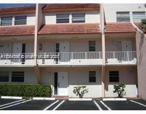 Front view of a multi-story residential building with balconies.