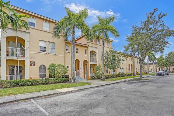 Front view of a multi-story residential building with balconies.