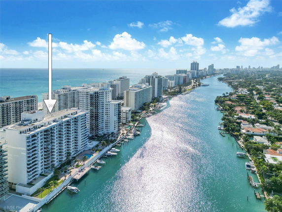 Panoramic view of waterfront high-rise buildings along a river and ocean.