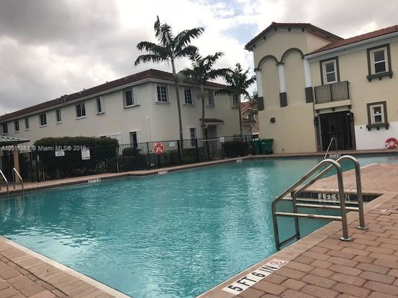 Outdoor swimming pool adjacent to residential buildings.